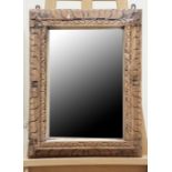 A wall mirror in heavy carved wood frame, 63 cm x 46 cm