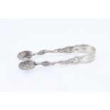 A pair of late 18th Century French silver sugar tongs, having cast naturalistic legs leaf shaped
