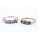 A lady's blue stone dress ring, having a line of oval blue stones (3 x 4 mm) set in a gallery
