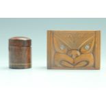 A New Zealand Maori influenced Paua shell inlaid carved wood trinket box, its lid decorated in