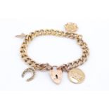A 9 ct yellow metal charm bracelet, having a gem set high carat yellow metal horseshoe charm,