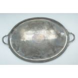 A large Victorian electroplate oval two handled tea tray, bearing a Durant family crest, 70 x 46 cm