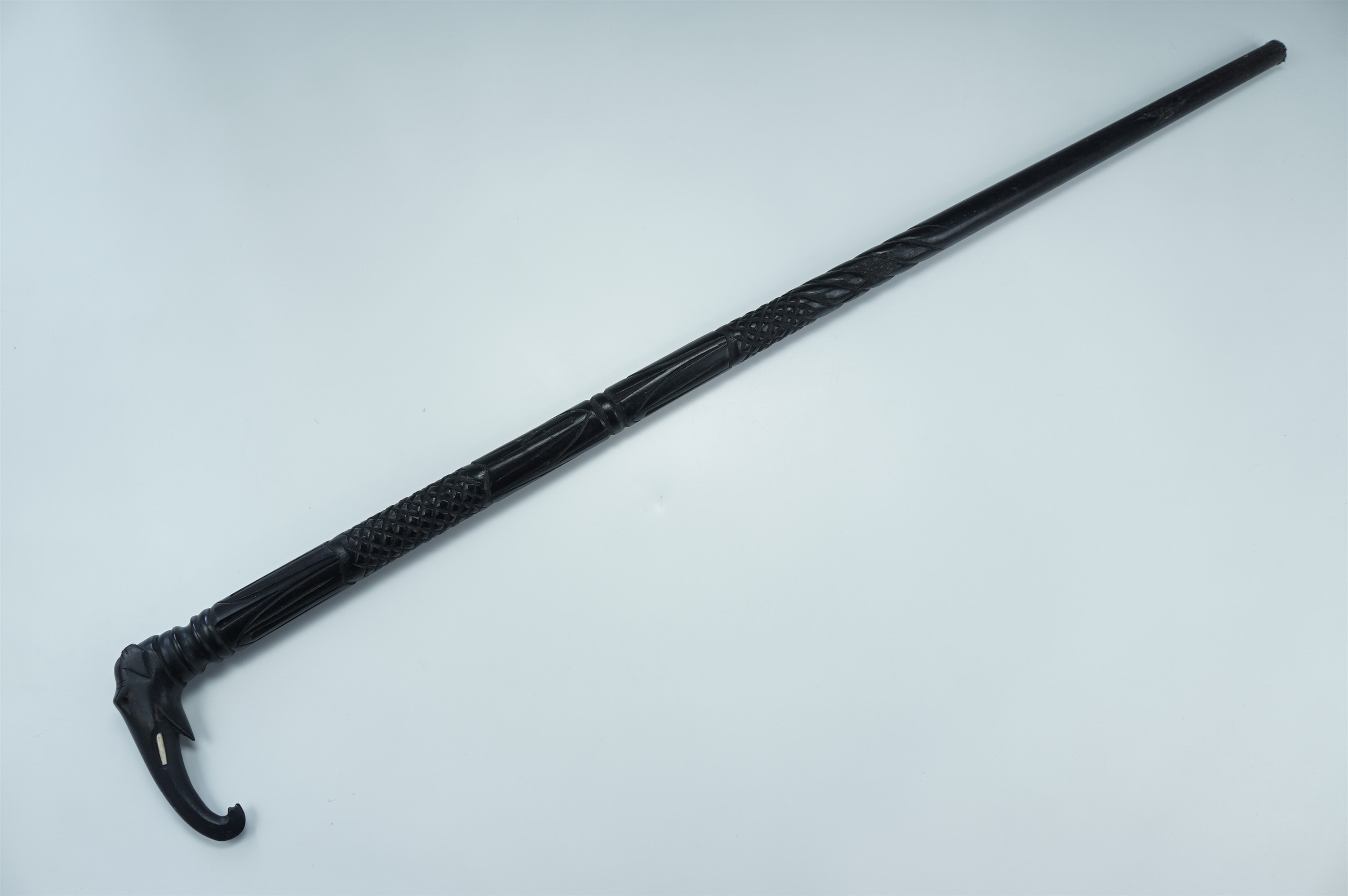 An Anglo-Indian carved ebony walking cane, its handle in the form of an elephant's head, 83 cm