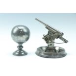 Two 1950s pewter novelty table lighters, being a petrol lighter in the form of an anti-aircraft gun,