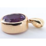 A modern amethyst pendant, the (9 x 7 mm) oval brilliant cut amethyst being bezel set on a loose