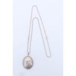A 1980s silver locket necklace, having a convex oval front with a rope twist border and bright cut