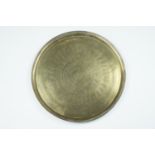 An early 20th Century Indian brass circular table top, having profuse chased decoration, 57.5 cm