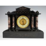 A Victorian marble mantle clock, having a drum movement in an architectural black marble case, the