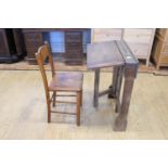 A late 19th / early 20th Century child's folding oak desk, 61 cm wide x 77 cm high, together with