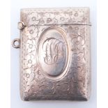 An early George V silver fob vesta case, of cushion form and decorated with engraved flowerheads