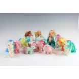 A group of Hasbro "My Little Pony" toys, together with a Barbie and two other dolls