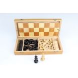 A cased folding wooden chess and checkers set, 30 x 13.5 x 5.5 cm