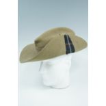 A 1942 dated British army slouch hat bearing a Highland Light infantry Mackenzie Tartan highland