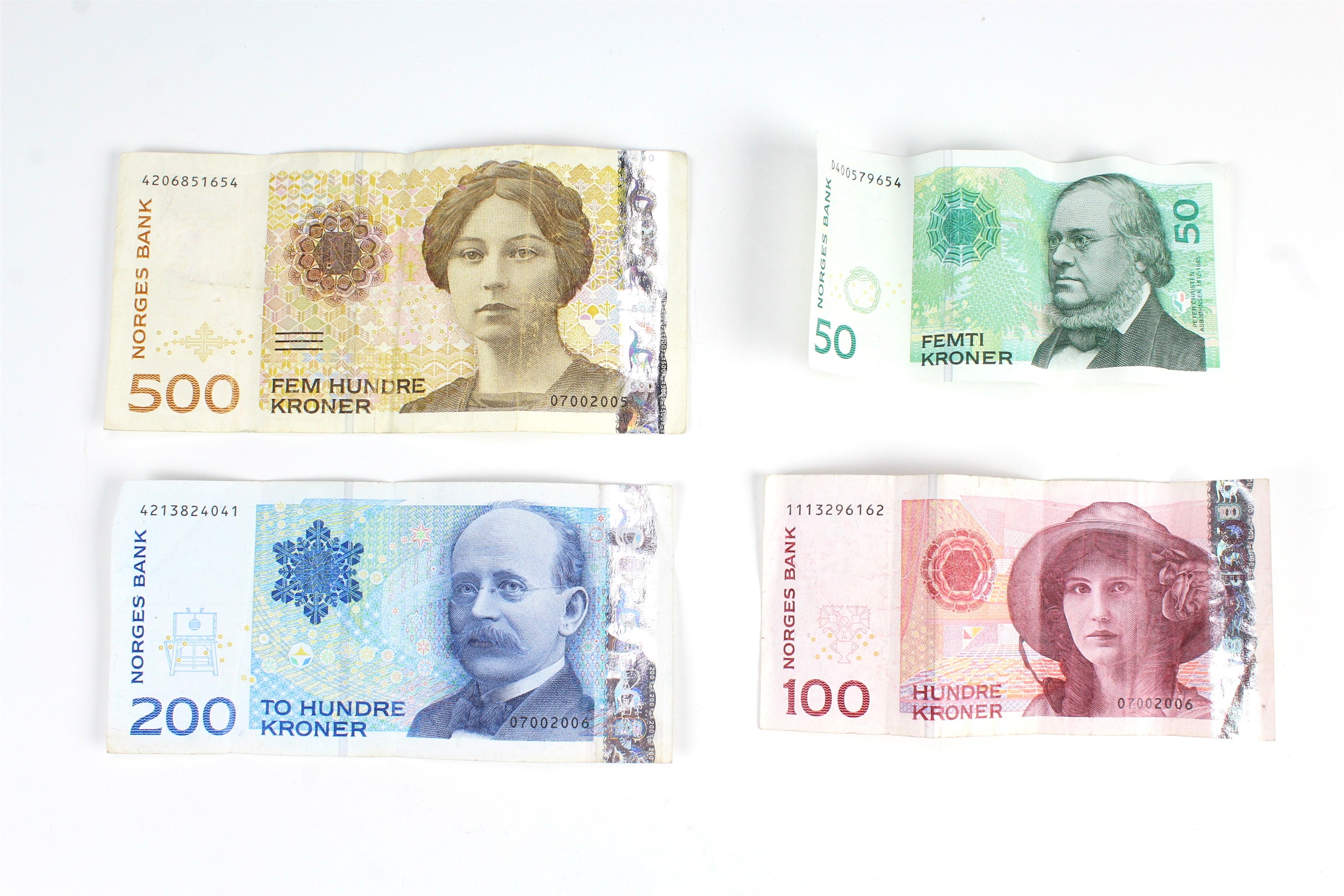 A small group of Norwegian Krone banknotes, comprising a 500, 200, 100 and 50 Krone notes