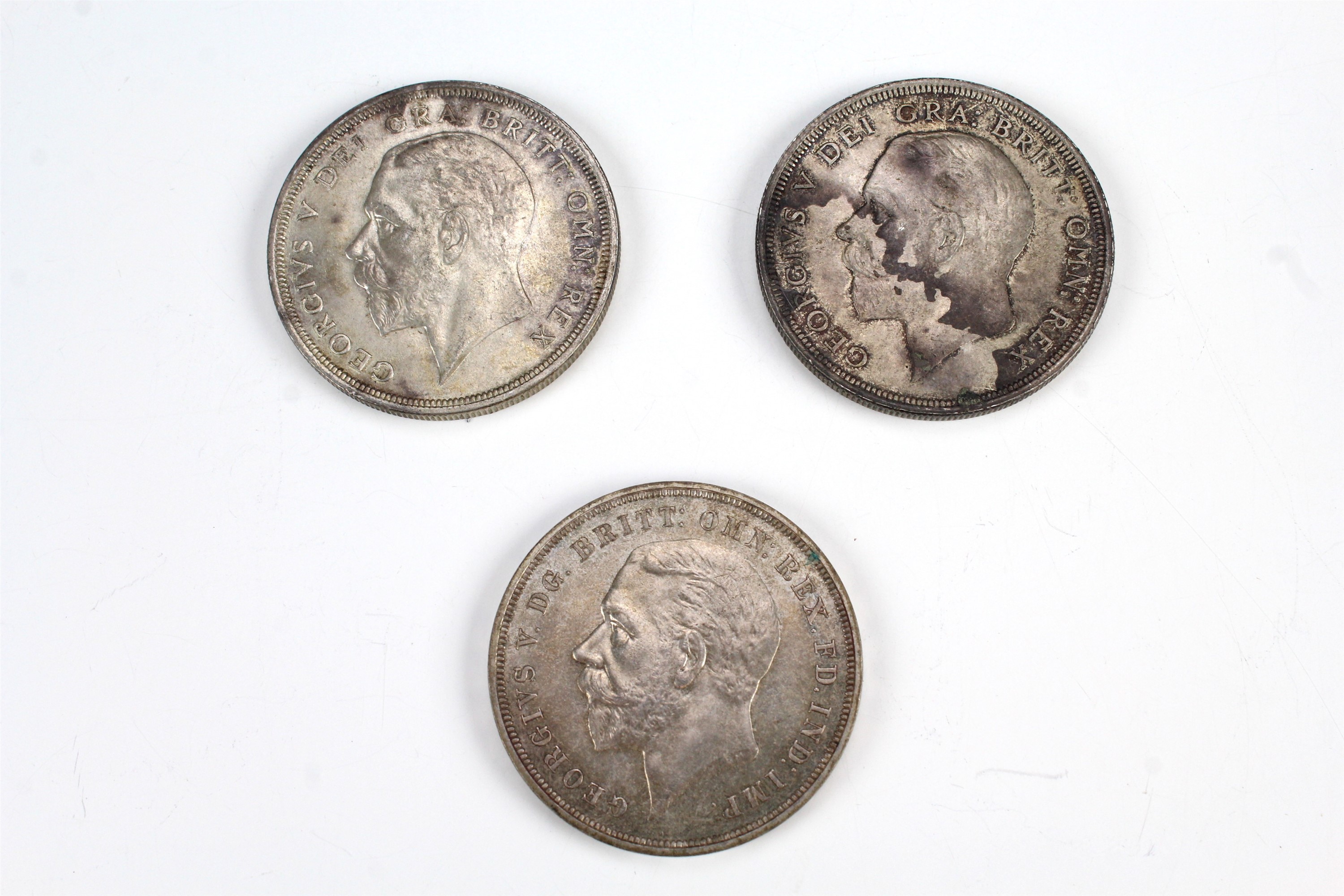 Two 1928 "wreath" crown coins together with a 1935 crown coin