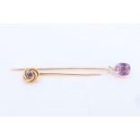 A Belle Epoque amethyst, diamond and yellow metal stick pin together with a sapphire and yellow