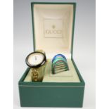 A 1990s lady's Gucci 1100-L wristwatch, having interchangeable bezels, boxed with warranty card