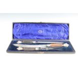 A Victorian three piece stag handled carving set, Christopher Johnson & Co, Sheffield, in silk and