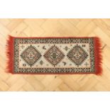A small hand woven Kazak Persian wool pile rug, 88 x 33 cm