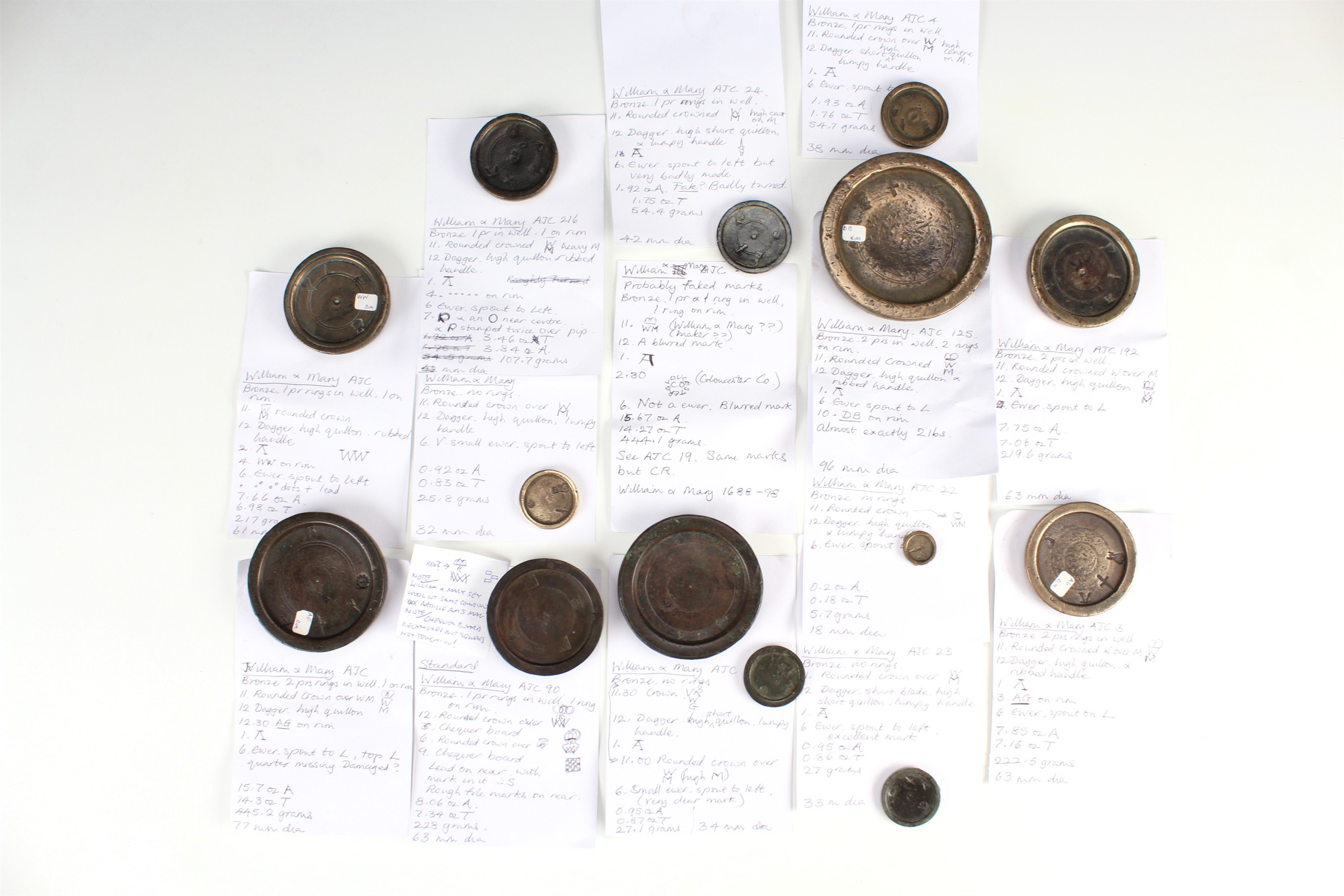 14 William and Mary bronze trade weights, including marks for 'Gloucester Co', and a chequerboard