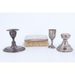 A group of silver, comprising two early 20th Century candlesticks, a mid 20th Century silver-