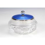 An Edwardian enamelled silver and cut glass powder jar, having a blue guilloche enamelled lid,
