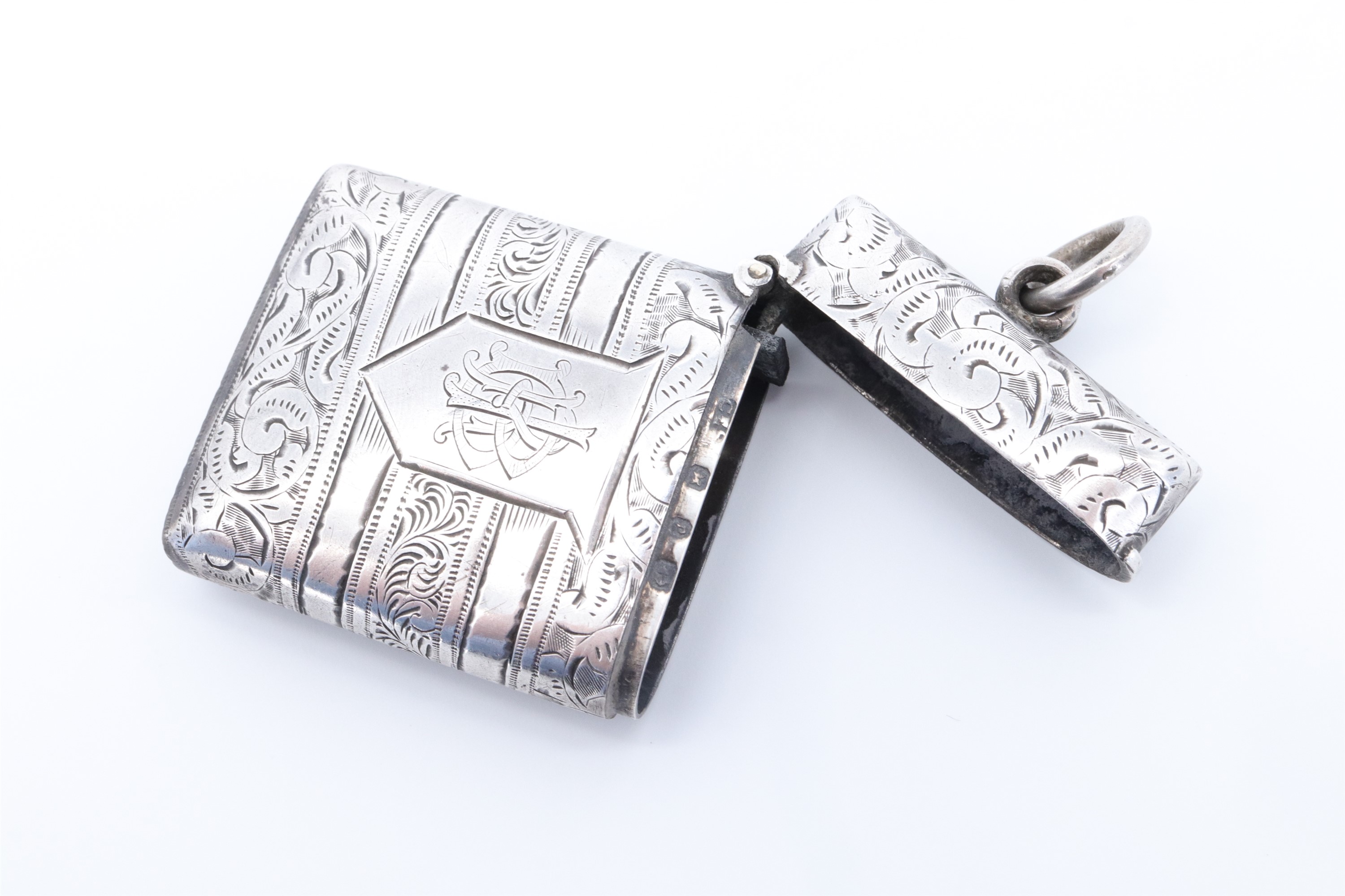 A late Victorian silver fob vesta case, of cushion form bearing banded foliate scroll engraved - Image 3 of 3
