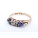 An early 20th Century sapphire and diamond ring, having two rows of three old cut diamonds (