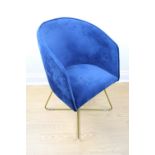 A contemporary designer blue upholstered and tubular metal framed tub armchair