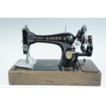 A late 19th Century Singer hand sewing machine together with a buttonhole attachment