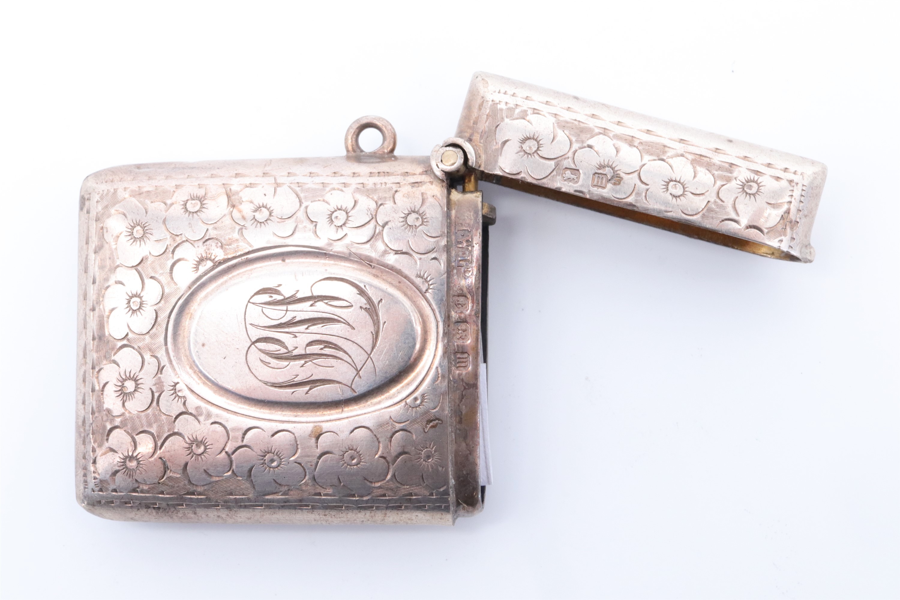 An early George V silver fob vesta case, of cushion form and decorated with engraved flowerheads - Image 3 of 4