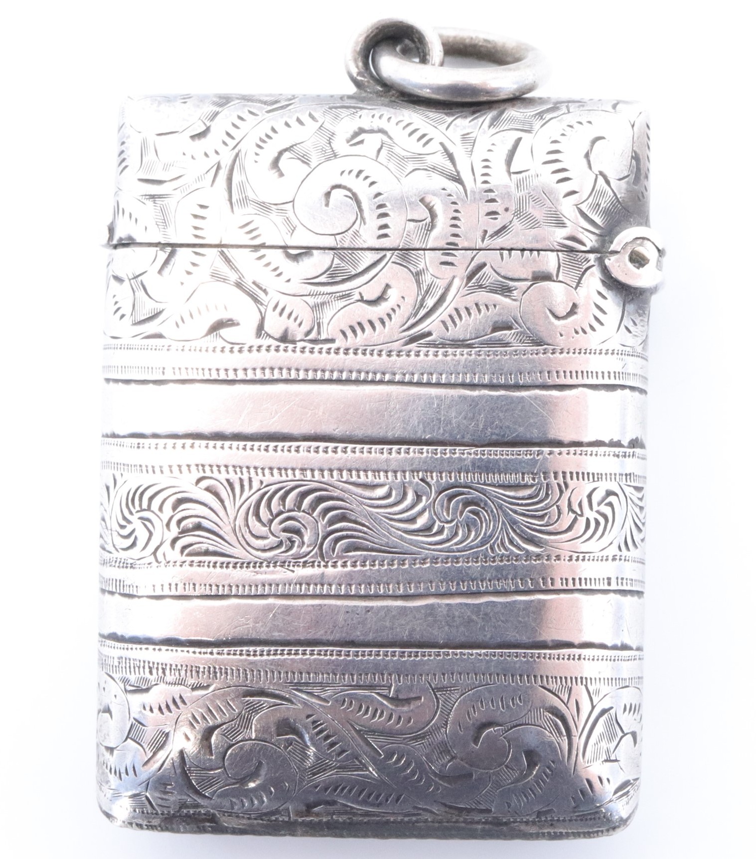 A late Victorian silver fob vesta case, of cushion form bearing banded foliate scroll engraved - Image 2 of 3