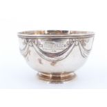 A George III silver bowl, decorated with repousse swags, IC, London, 1783, bearing an engraved