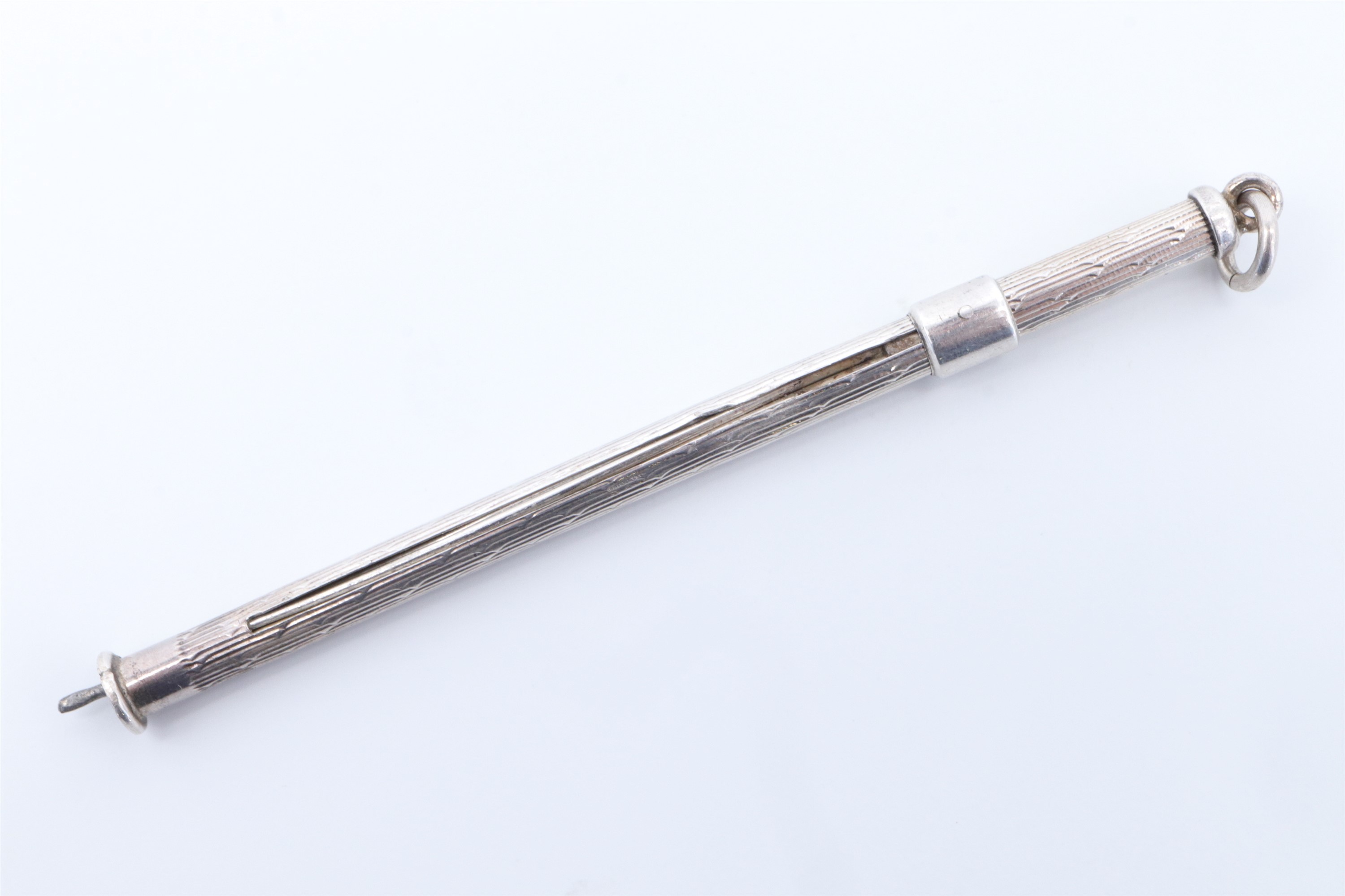 A silver cocktail swizzle stick, 7.5 cm with tines retracted - Image 2 of 3