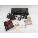 A Sinclair ZX Spectrum +2 home computer, together with a Sinclair light gun, power supply unit,