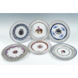 A set of six 18th Century style armorial porcelain plates, having radially reticulated rims, bearing