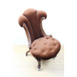 A Victorian flamboyant upholstered mahogany nursing chair
