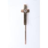 A modern yellow metal and garnet tie stick pin in the form of a cross, having a small white stone
