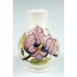 A magnolia pattern Moorcroft vase, of baluster form with a cream body, impress marks, 13.5 cm