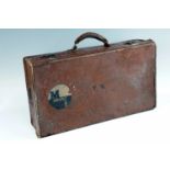 A vintage hide suitcase bearing Orient Line labels, 66 cm x 36 cm x 17 cm