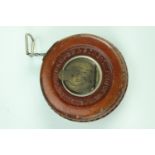 A John Rabone & Sons leather bound steel tape measure, 8 cm diameter