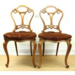 A set of four Victorian carved and upholstered walnut salon / dining chairs