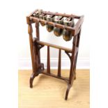 An early 19th Century set of brass chimes / gongs on oak stand, 42 cm x 80 cm