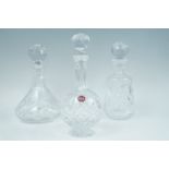 Three late 20th Century cut glass decanters, tallest 28 cm