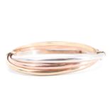 A 9 ct three colour triple-hoop bangle, 6 cm x 5.5 cm internally, 11.4 g