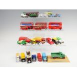 A group of vintage play-worn diecast advertising vehicles, busses, and trains, including Corgi,