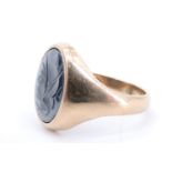 A 9 ct gold signet ring having an oval haematite matrix intaglio carved in depiction of the
