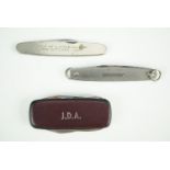 Three clasp knives, including one engraved "Workington Iron & Steel Company. Visit of H.M The