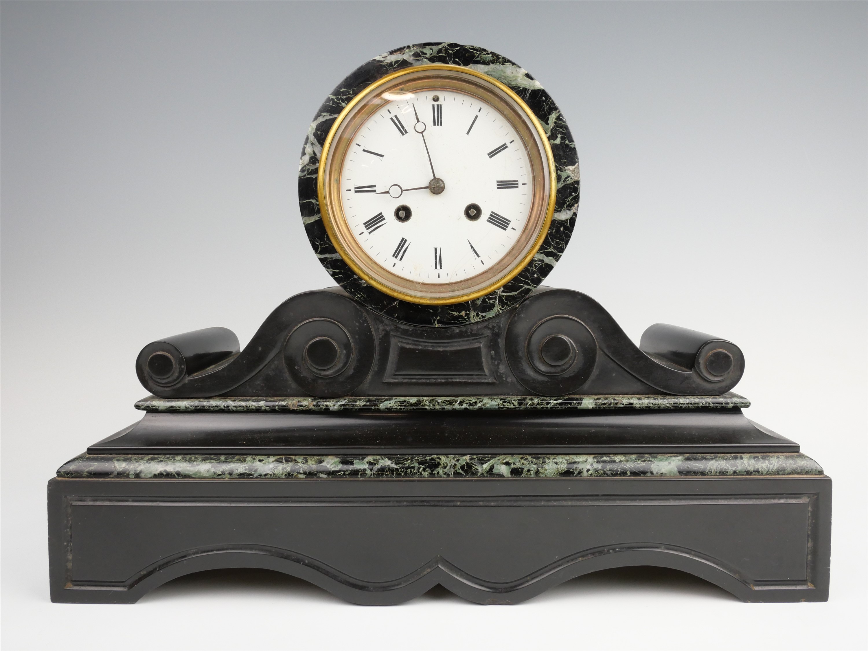 A Victorian marble mantle clock, having a two train drum movement striking on a bell in a black
