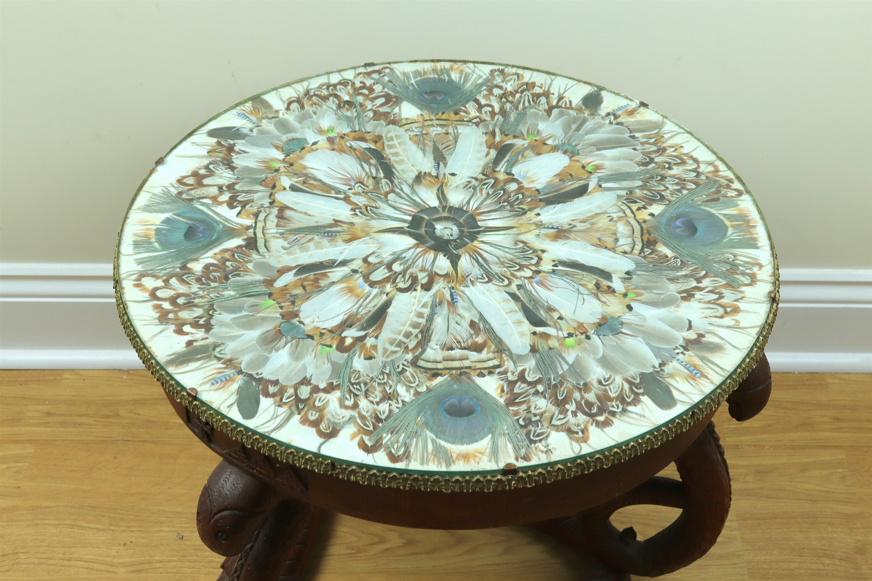 A mid-20th Century Egyptian coffee table, having a glass top enclosing a radial display of peacock - Image 2 of 3